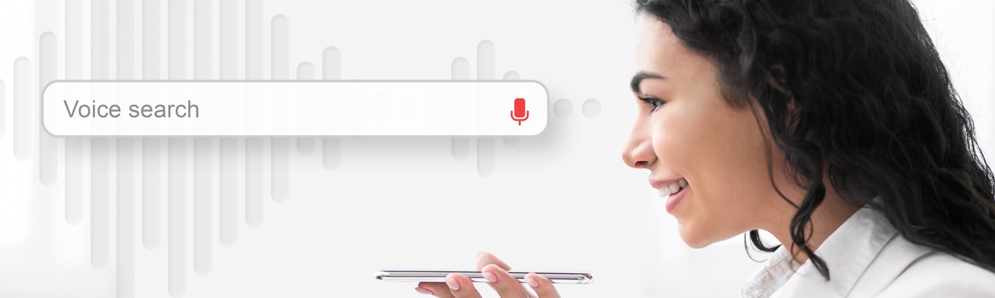 Businesswoman Using Voice Search On Mobile Phone, White Background, Side-View