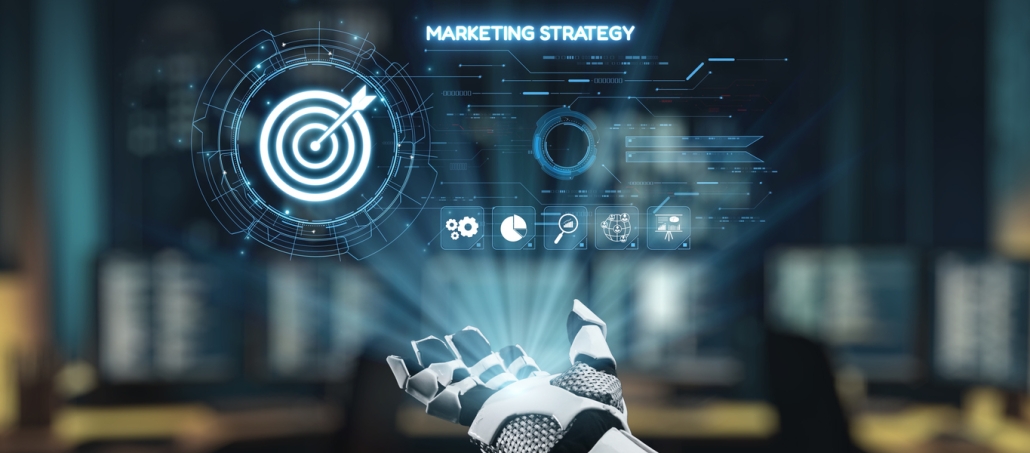A robotic hand points toward a holographic display with a target symbol and digital icons. The words MARKETING STRATEGY appear above, highlighting the impact of Artificial Intelligence in Digital Marketing against blurred computer screens.