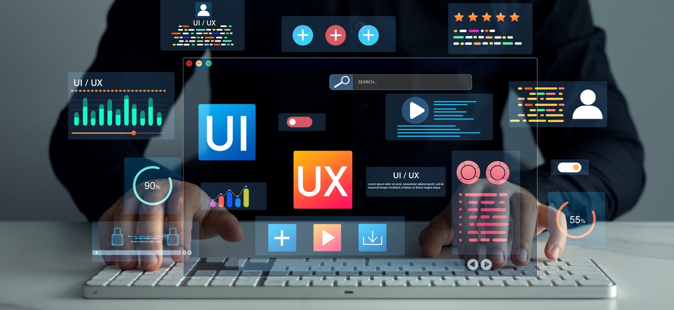 A person typing on a keyboard with various colorful UI and UX digital interface icons and graphs hovering above, representing user experience and user interface design concepts.