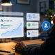 A person sits at a desk looking at virtual screens displaying Google Ads analytics graphs, search, audience, performance, and automation icons in a modern, dimly lit office.