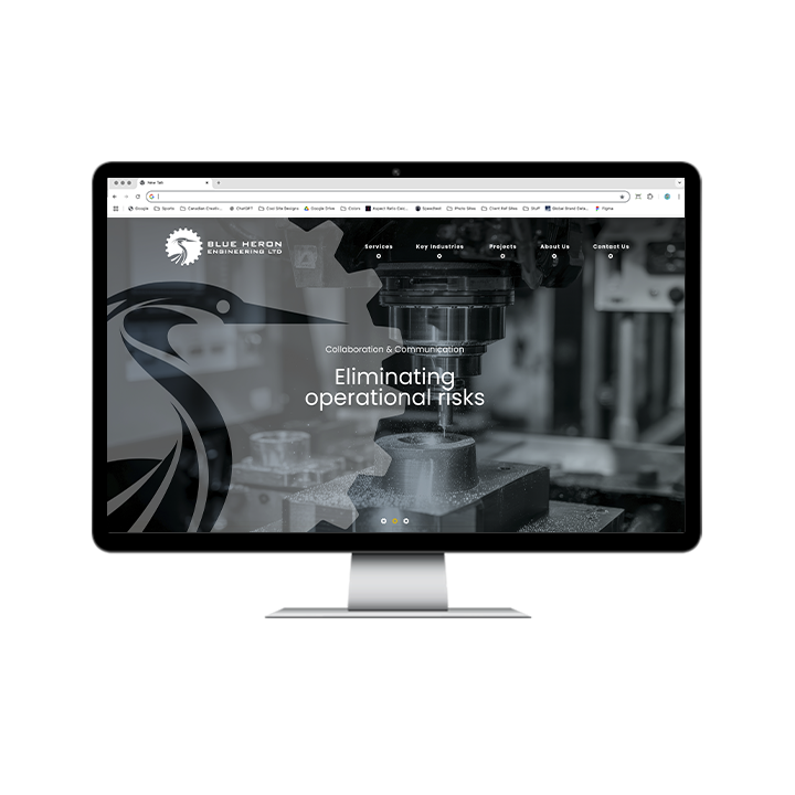 AG Client Page Blue Heron BV2 A computer monitor displaying the Blue Heron Engineering Ltd website, featuring the company logo, a hero image of a machining tool, and the text Collaboration & Communication: Eliminating operational risks.