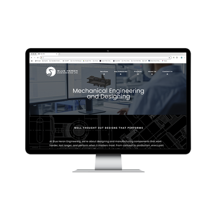AG Client Page Blue Heron Web1 A computer monitor displaying the Blue Heron Engineering website homepage, featuring the company logo, a hero image of a workstation, and the text Mechanical Engineering and Designing.