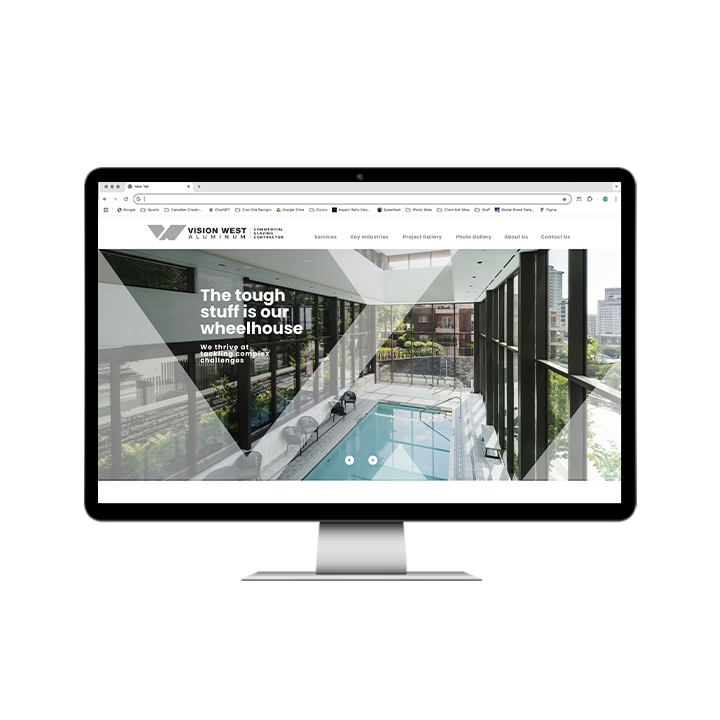 AG Client Page Vision West BV4 A computer monitor displaying the Vision West Aluminum website, featuring a hero image of a modern indoor pool area and text reading, The tough stuff is our wheelhouse.