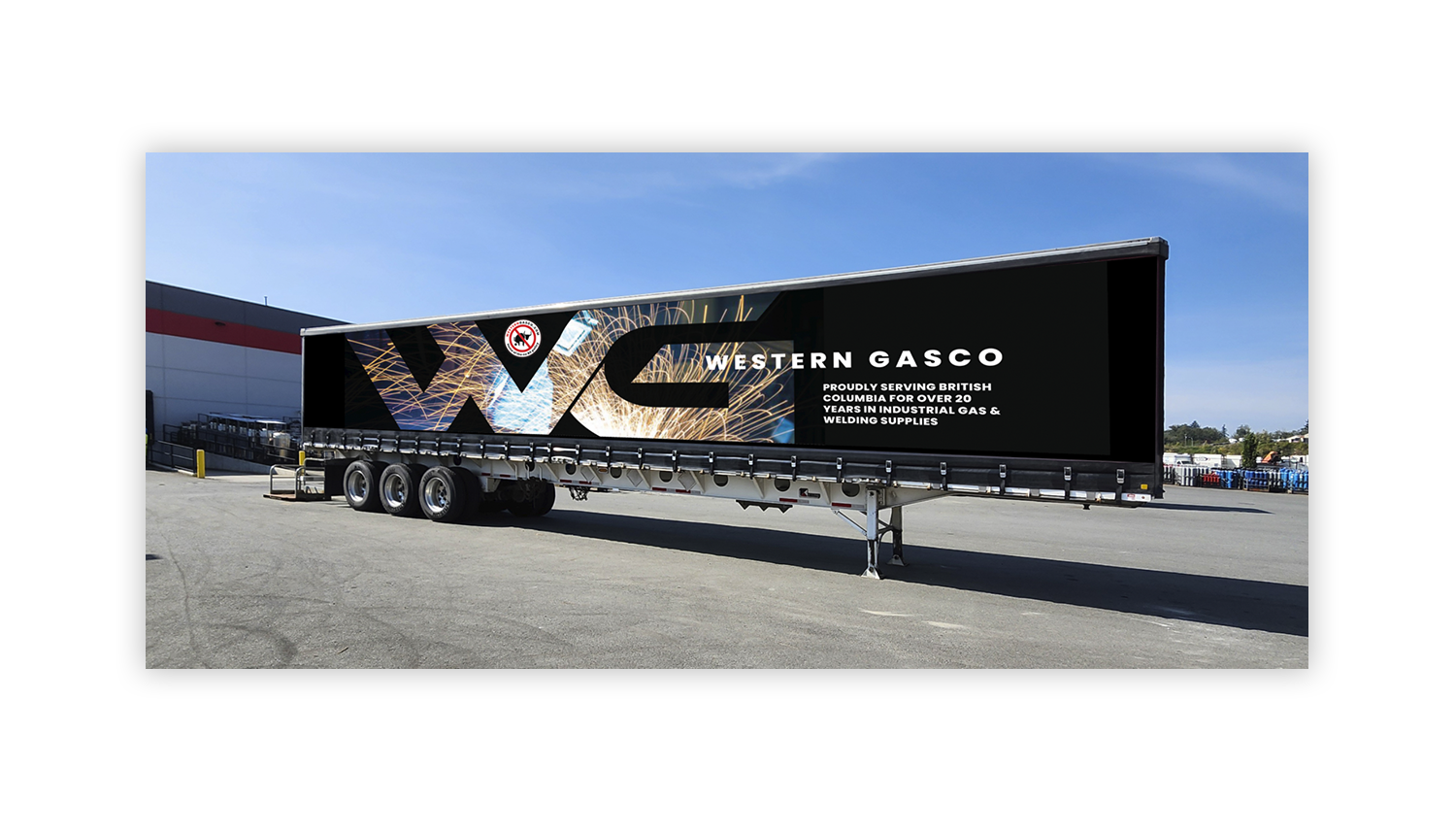 AG Client Page Western Gasco Trailer A flatbed trailer parked in a lot, with the side branded Western Gasco and text advertising industrial gas and welding supplies.