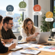 Three colleagues collaborate at a desk with a laptop, overlaid with an infographic showing six services from our personalized digital marketing agency: SEO & AI Search, Strategy, Digital Advertising, Branding, Website Development, and Analytics.